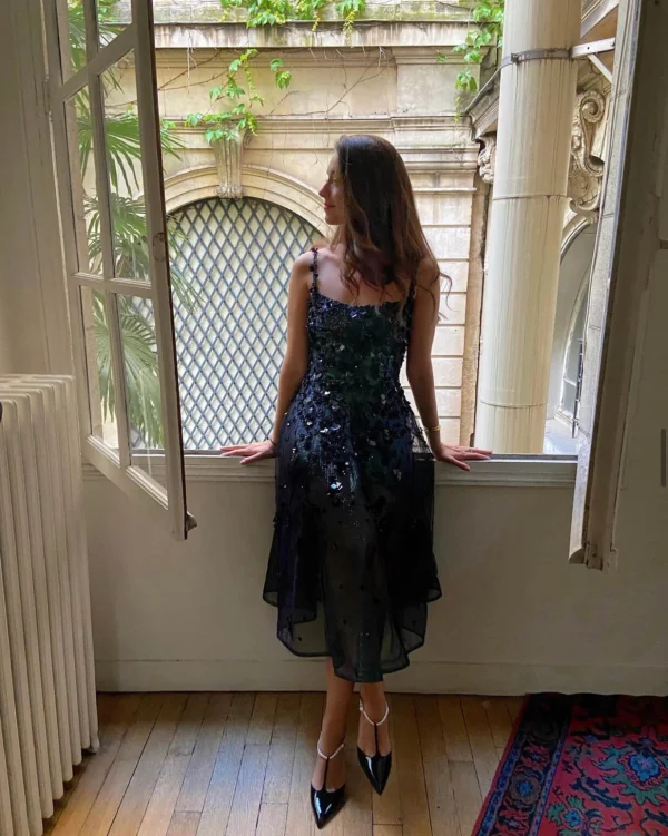 Elegant-woman-standing-in-a-window-frame