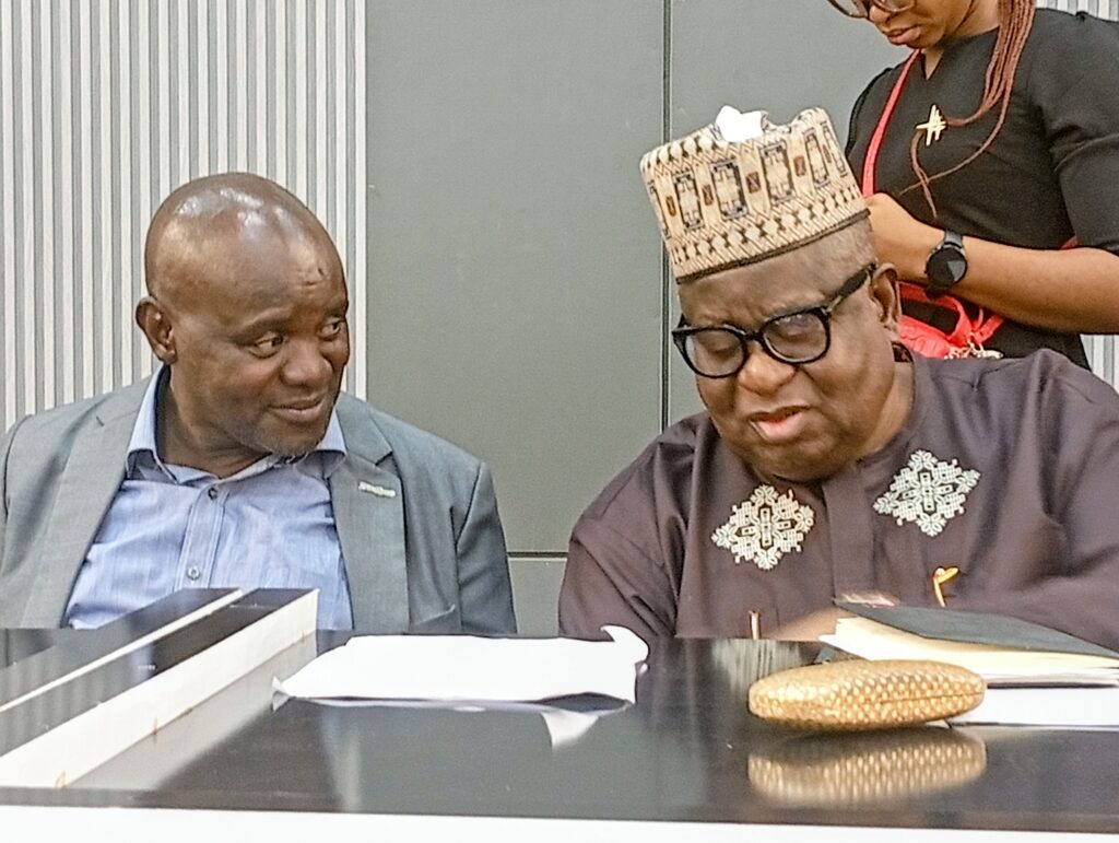 Mr G. T. Adeiye the incoming Chairman and Chief Fassy Yusuf the outgoing chairman